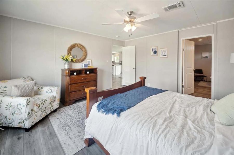 Bedroom with ceiling fan and wood-type flooring