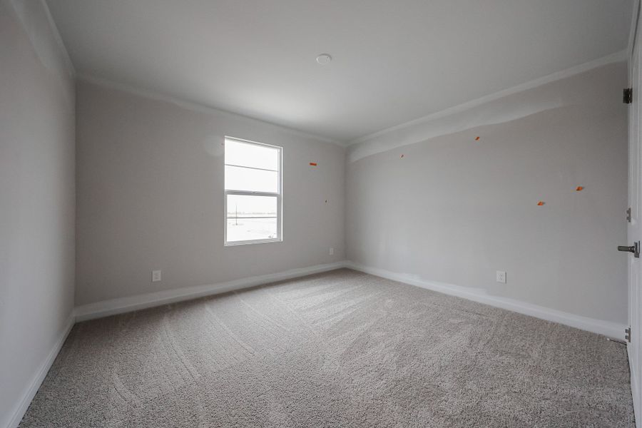 A room with a carpet and a window. A room with a carpet and a window.