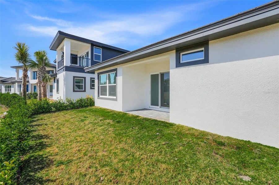 Exterior details and patio area of a home in Hampton Green at Providence, Davenport (Image 3).