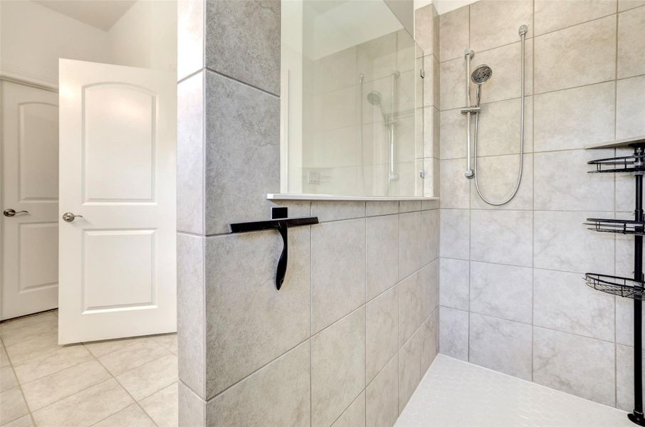 Full bathroom featuring a walk in shower and tile patterned floors