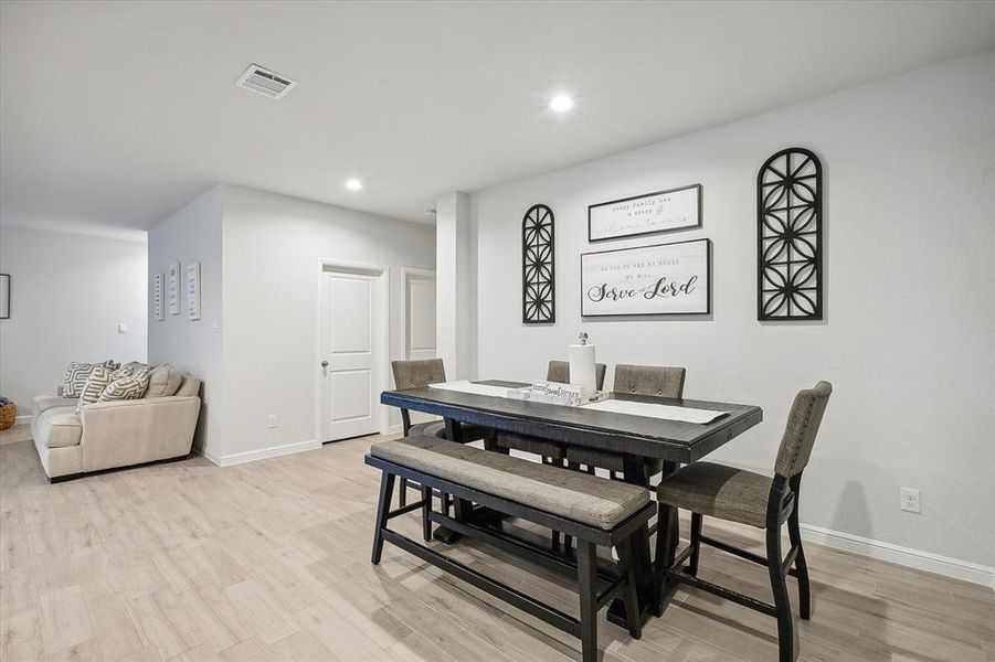 Dining space with light wood-type flooring Dining space with light wood-type flooring