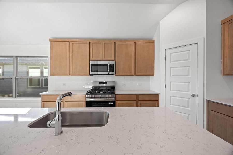 Kitchen in the Turquoise home plan by Trophy Signature Homes – REPRESENTATIVE PHOTO
