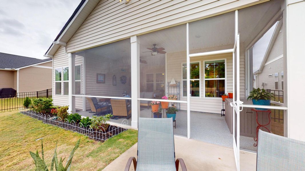Exterior details and patio area of a home in Summerwind Crossing at Lakes of Cane Bay, Summerville (Image 29).