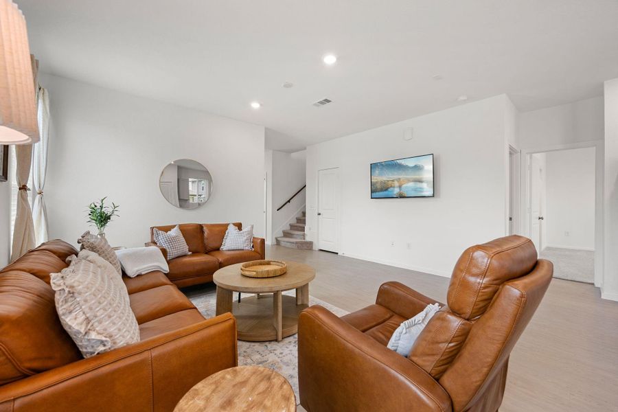 The open floor plan effortlessly connects the living room, dining space, and kitchen, making everyday living and hosting a breeze. Large windows throughout create a bright and airy atmosphere.