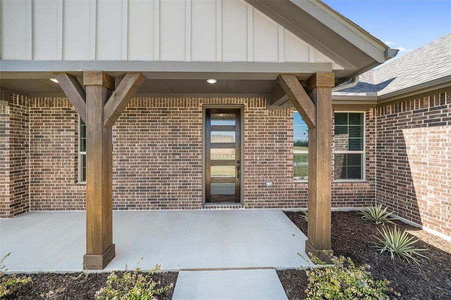 Front exterior of a new home in Oak Grove Addition, Springtown, TX, highlighting curb appeal (Image 22). Front exterior of a new home in Oak Grove Addition, Springtown, TX, highlighting curb appeal (Image 22).