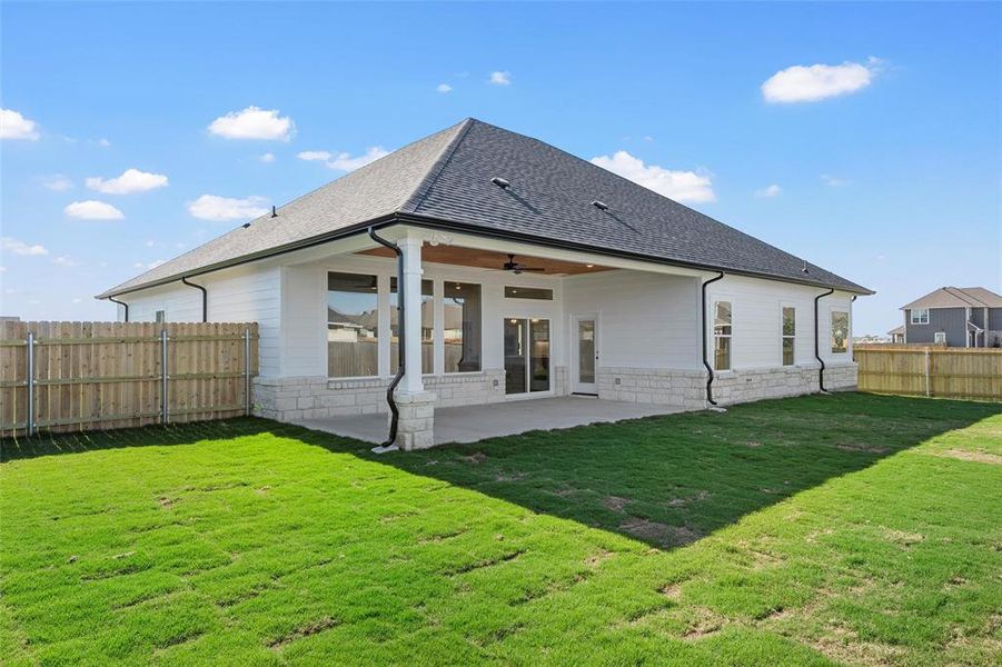 Back of house featuring ceiling fan, a fenced backyard, a patio area, and roof with shingles