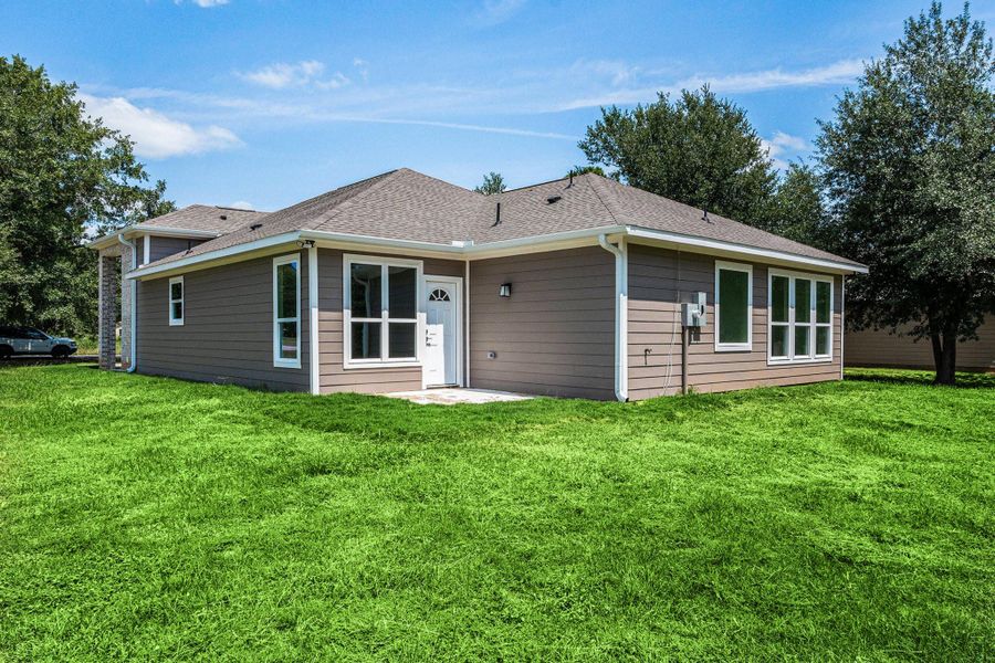 This is a modern, single-story home with a clean exterior, featuring multiple large windows and a well-maintained lawn. It’s surrounded by mature trees, offering a serene environment. This is a modern, single-story home with a clean exterior, featuring multiple large windows and a well-maintained lawn. It’s surrounded by mature trees, offering a serene environment.