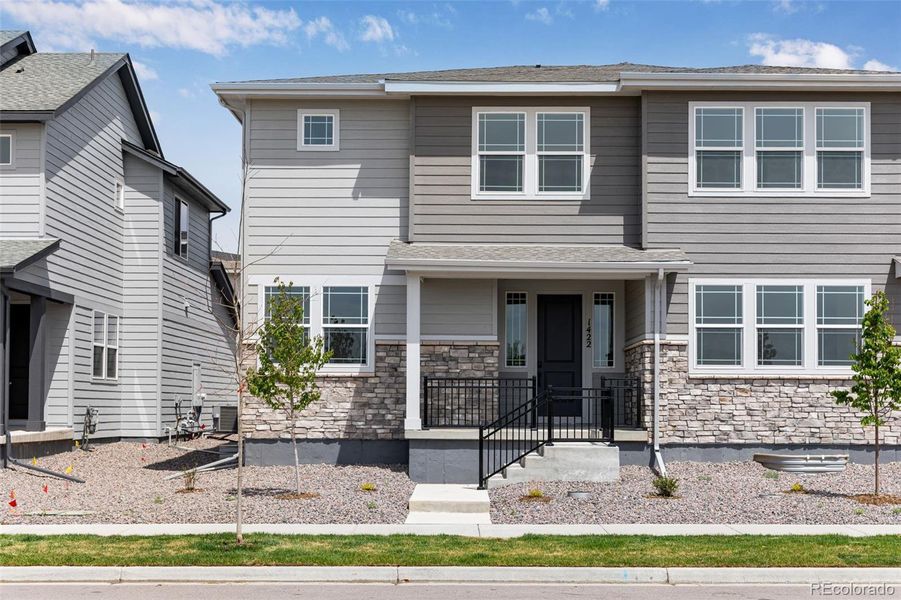 Front exterior of a new home in Sugar Mill Village, Longmont, CO, highlighting curb appeal (Image 2).