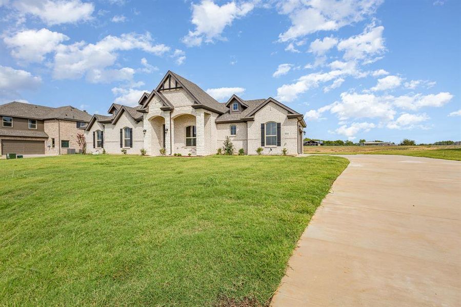Front exterior of a new home in Stone Henge II, Sanger, TX, highlighting curb appeal (Image 18).