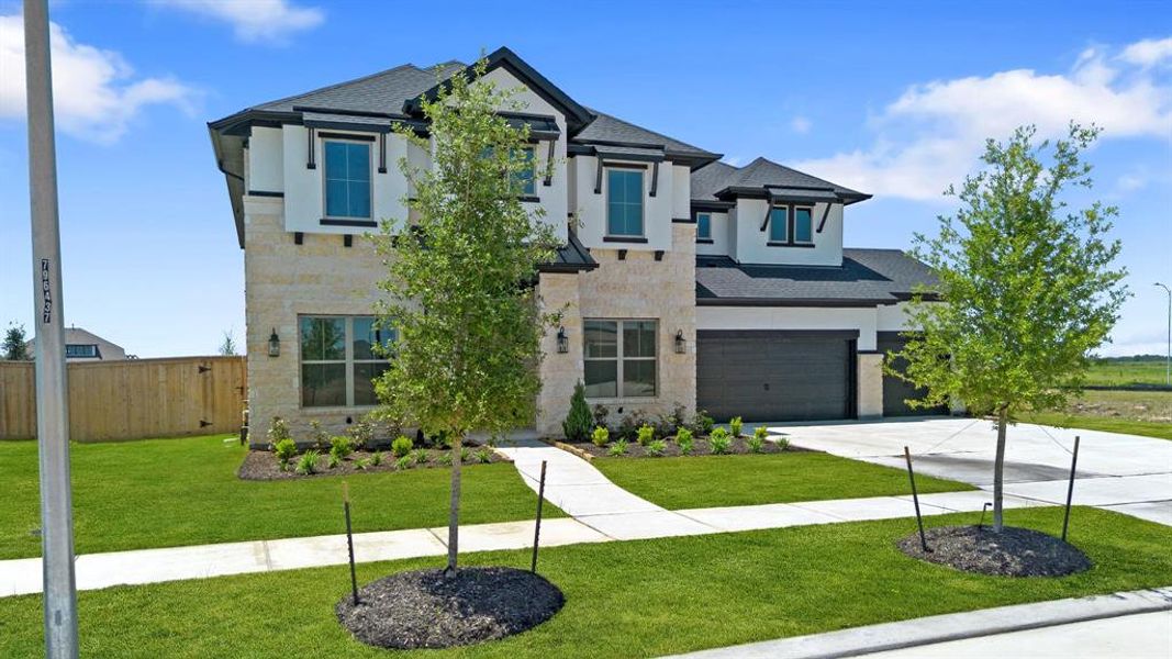 Front exterior of a new home in Valencia 60', Manvel, TX, highlighting curb appeal (Image 21).