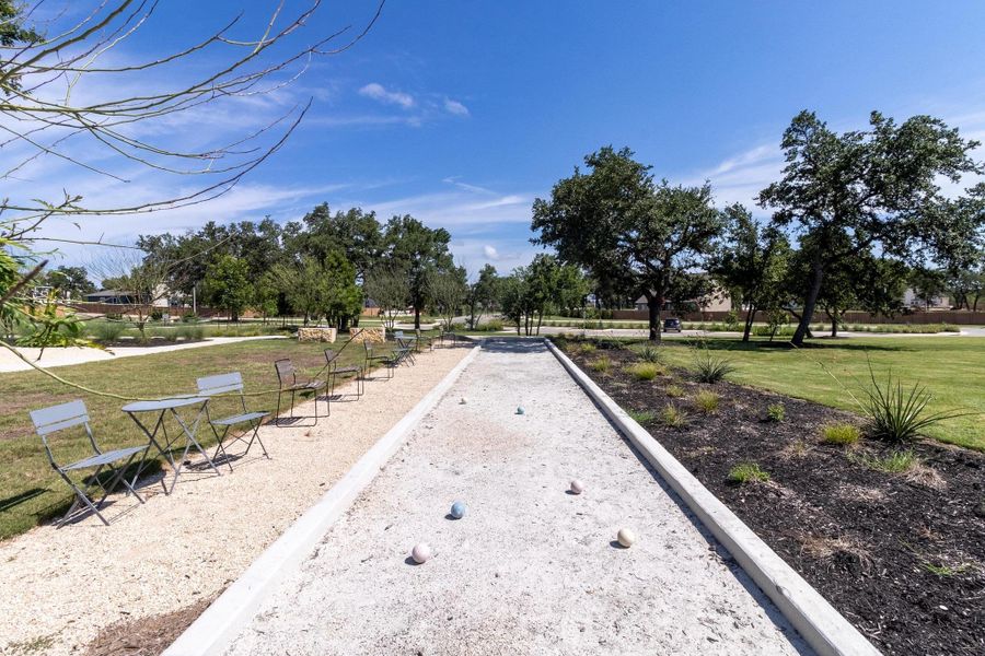 Bocce ball courts with stylish café seating offer a unique way to engage with neighbors.