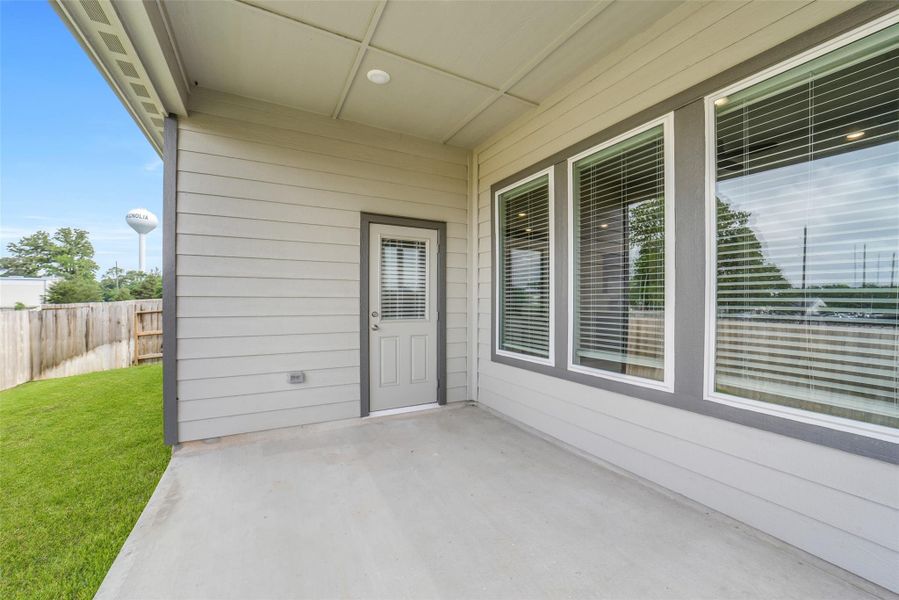 Exterior details and patio area of a home in Windmill Estates, Magnolia (Image 33).