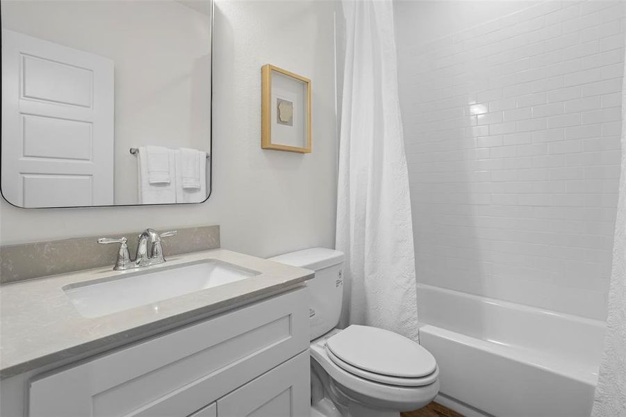 Full bathroom with toilet, shower / tub combo, and oversized vanity