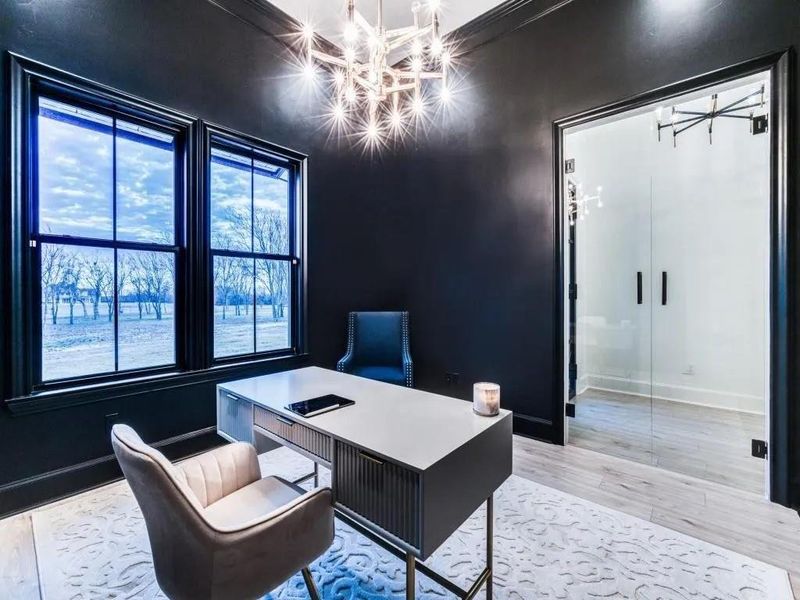 Office area featuring a chandelier and light wood-type flooring