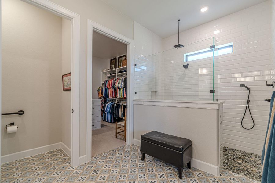 Full bathroom with walk in shower, a walk in closet, recessed lighting, and tile patterned floors