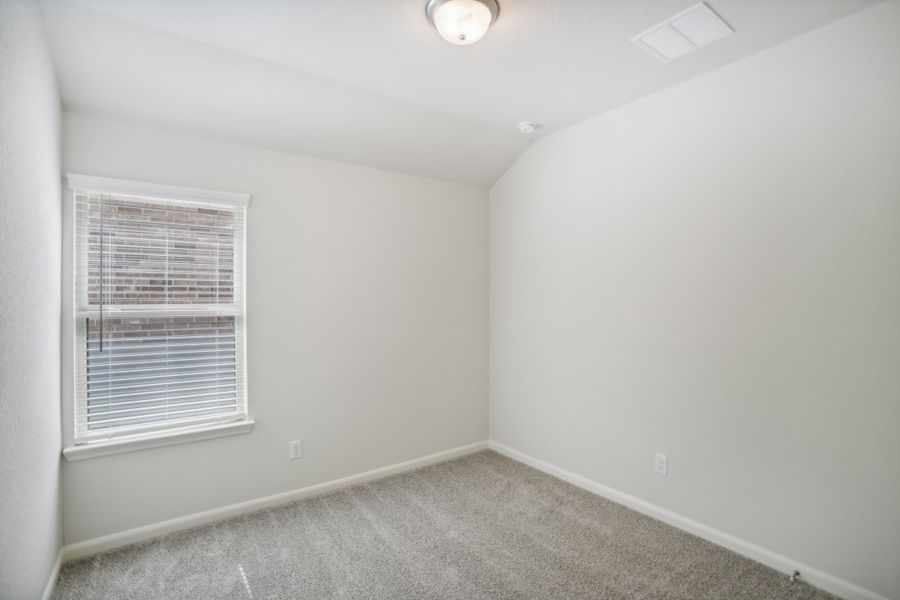 Guest bedroom in the Callaghan floorplan at a Meritage Homes community.