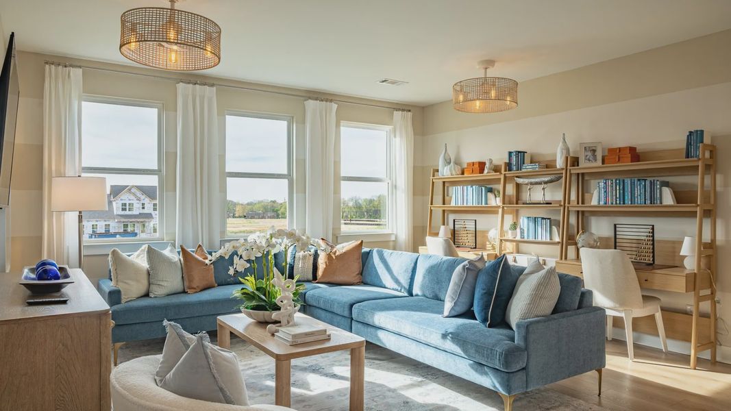 Bonus room with large sectional, TV, and desk areas