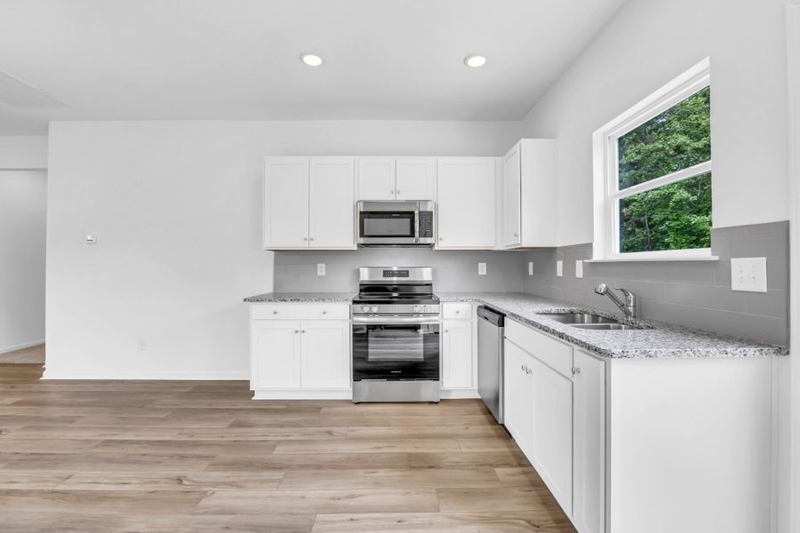 Beautiful granite and bright white cabinetry.