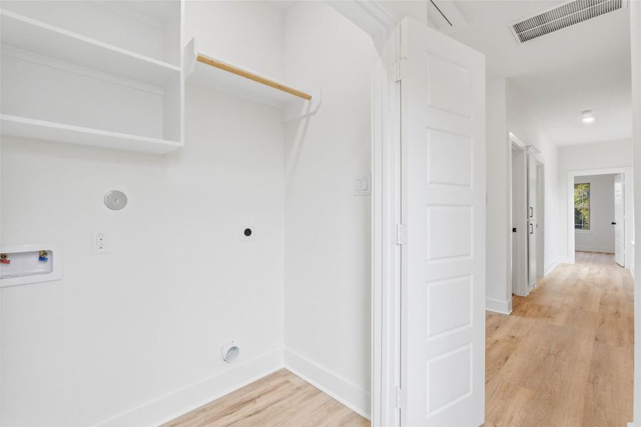 Upstairs laundry room with washer/dryer connections and shelving. Did I mention no carpet anywhere in the home!?