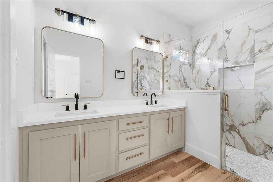 Bathroom with walk in shower, vanity, and hardwood / wood-style flooring