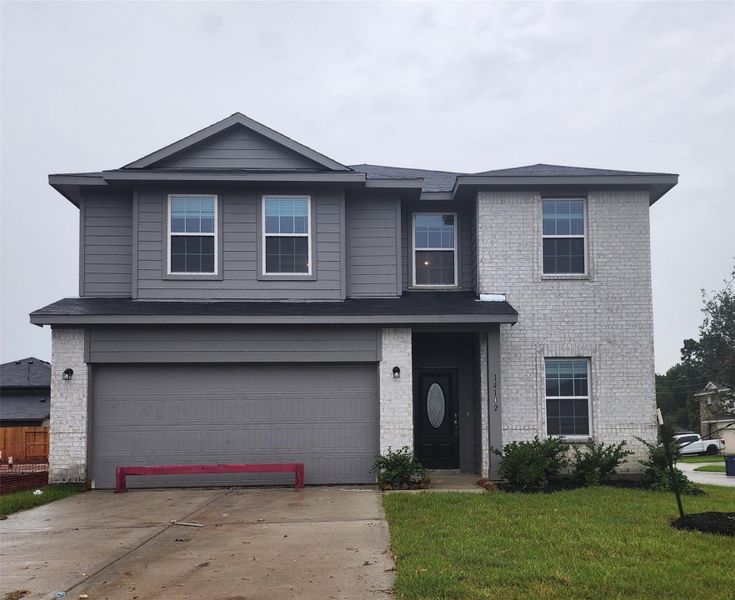 Front exterior of a new home in Pecan Estates, Crosby, TX, highlighting curb appeal (Image 2). Front exterior of a new home in Pecan Estates, Crosby, TX, highlighting curb appeal (Image 2).