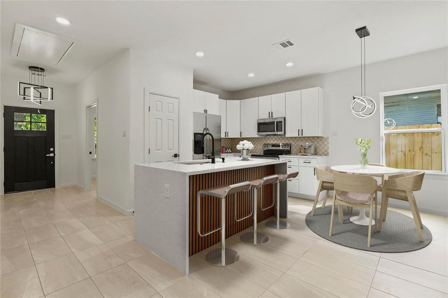 Kitchen featuring decorative backsplash, stainless steel appliances, light countertops, light tile patterned flooring, and white cabinetry