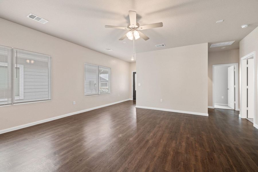 Spare room featuring dark wood-style floors and ceiling fan