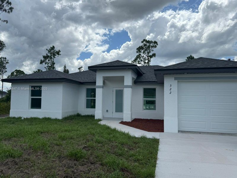 Front exterior of a new home in , Lehigh Acres, FL, highlighting curb appeal (Image 14). Front exterior of a new home in , Lehigh Acres, FL, highlighting curb appeal (Image 14).