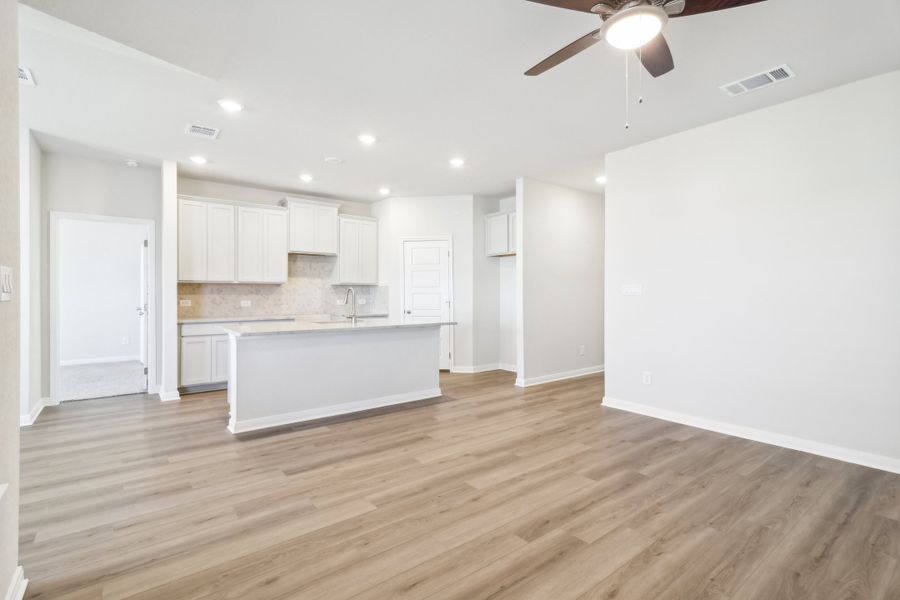 Living room and kitchen in the Briscoe floorplan at a Meritage Homes community.