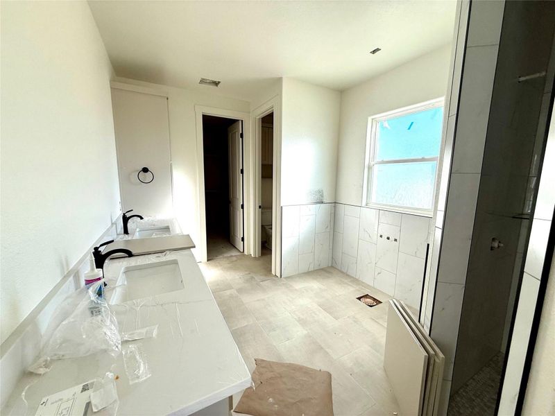 Full bathroom featuring double vanity and toilet Full bathroom featuring double vanity and toilet