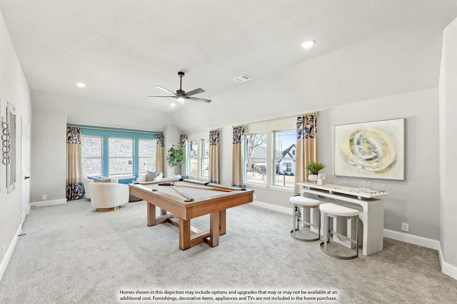 Game room with wood pool table, vaulted ceiling, ceiling fan, and carpet flooring Game room with wood pool table, vaulted ceiling, ceiling fan, and carpet flooring