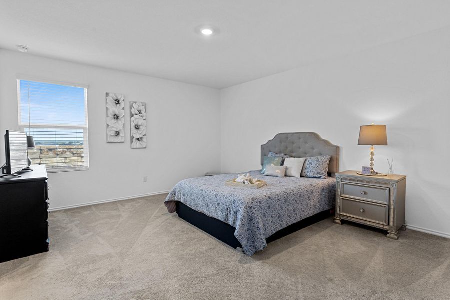 Carpeted room featuring a single window with horizontal blinds, white walls, and a recessed ceiling light