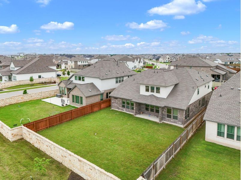Discover a spacious backyard, offering a private green retreat within this vibrant neighborhood.