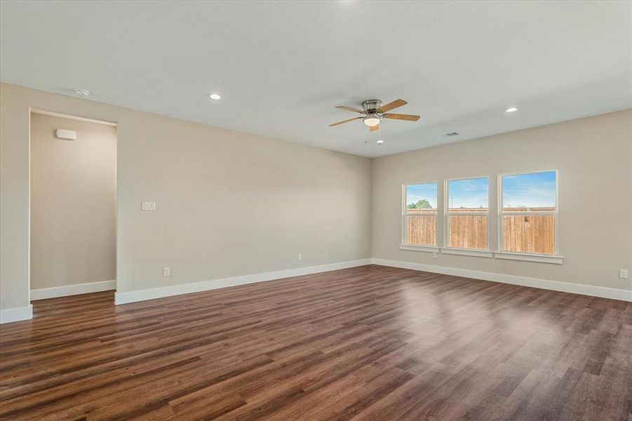 Empty room featuring dark hardwood / wood-style floors and ceiling fan Empty room featuring dark hardwood / wood-style floors and ceiling fan