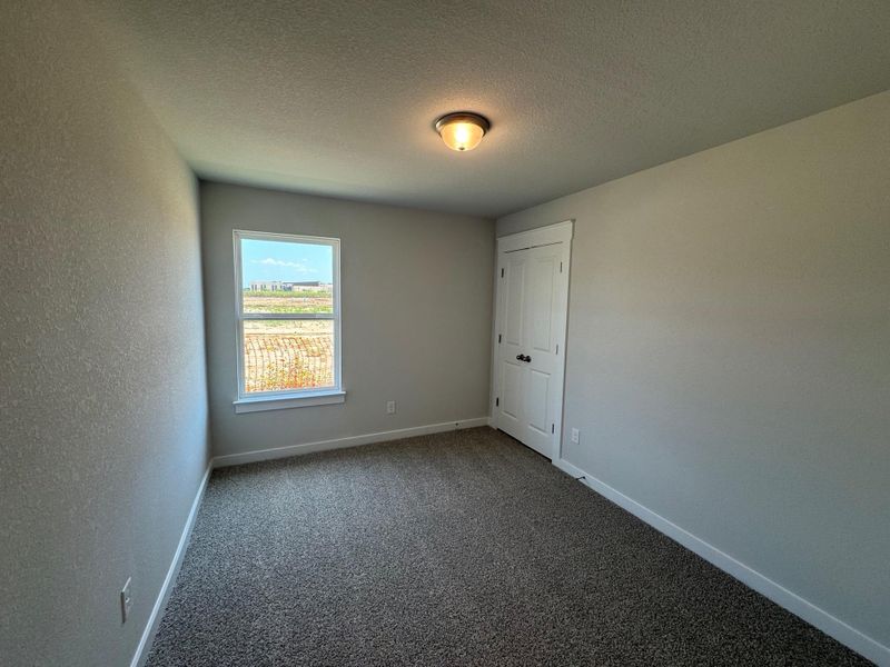 Unfurnished room with carpet and a textured ceiling Unfurnished room with carpet and a textured ceiling