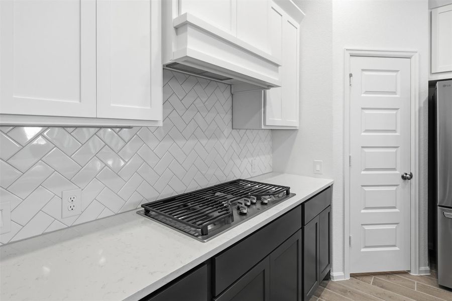 Sleek kitchen with a modern gas cooktop, offering both style and functionality.