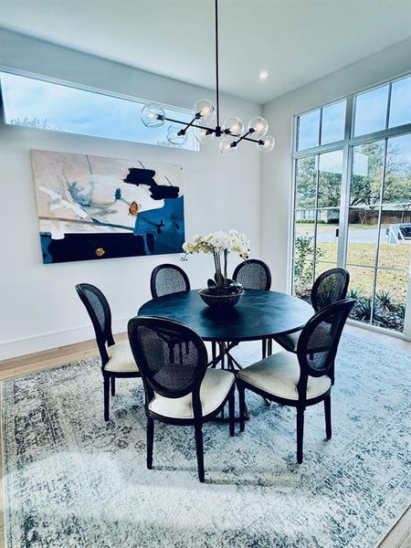 Dining space featuring a chandelier and hardwood / wood-style flooring