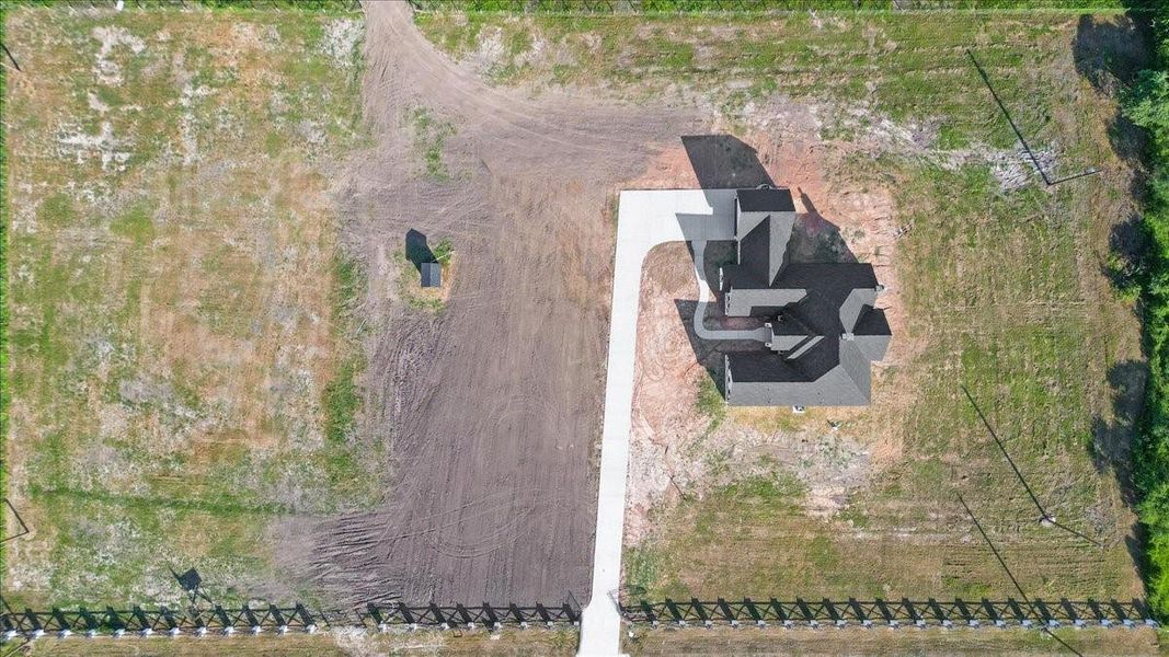 Overhead aerial view highlighting the home's footprint, driveway, and expansive acreage. Overhead aerial view highlighting the home's footprint, driveway, and expansive acreage.