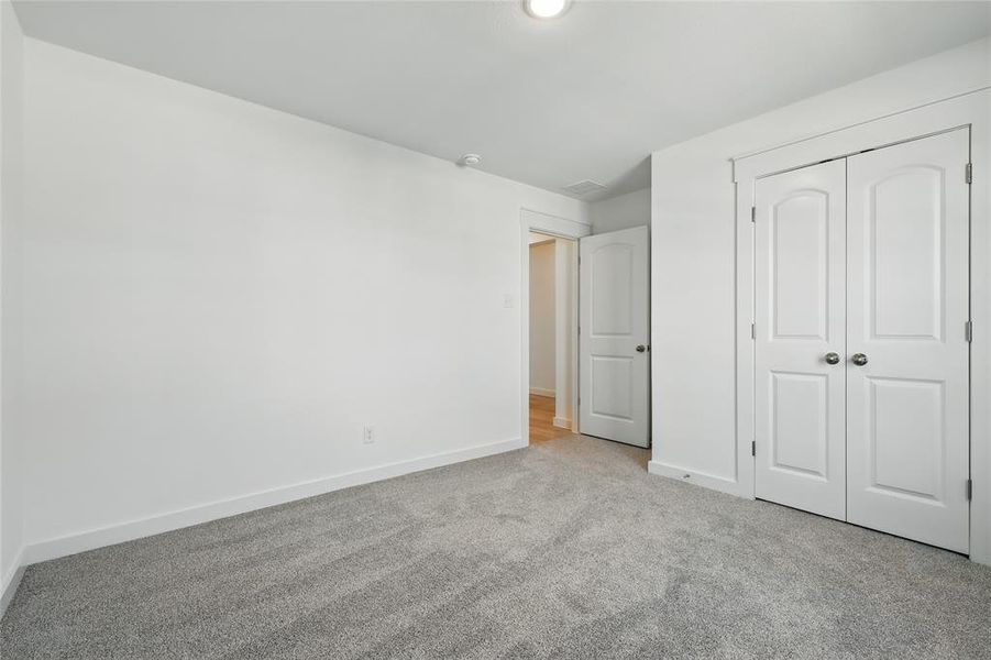 Unfurnished bedroom featuring carpet floors and a closet