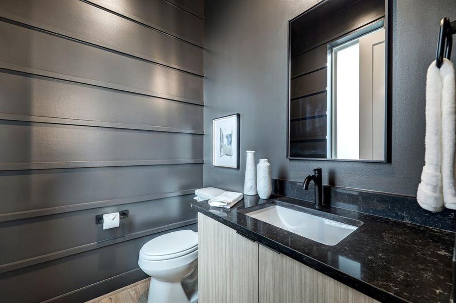 Photos are of 1502 A Ennis, the staged model at Linear on Bell. Choose from two design packages and floor plans. Wait until you see the light fixture in this moody powder room.