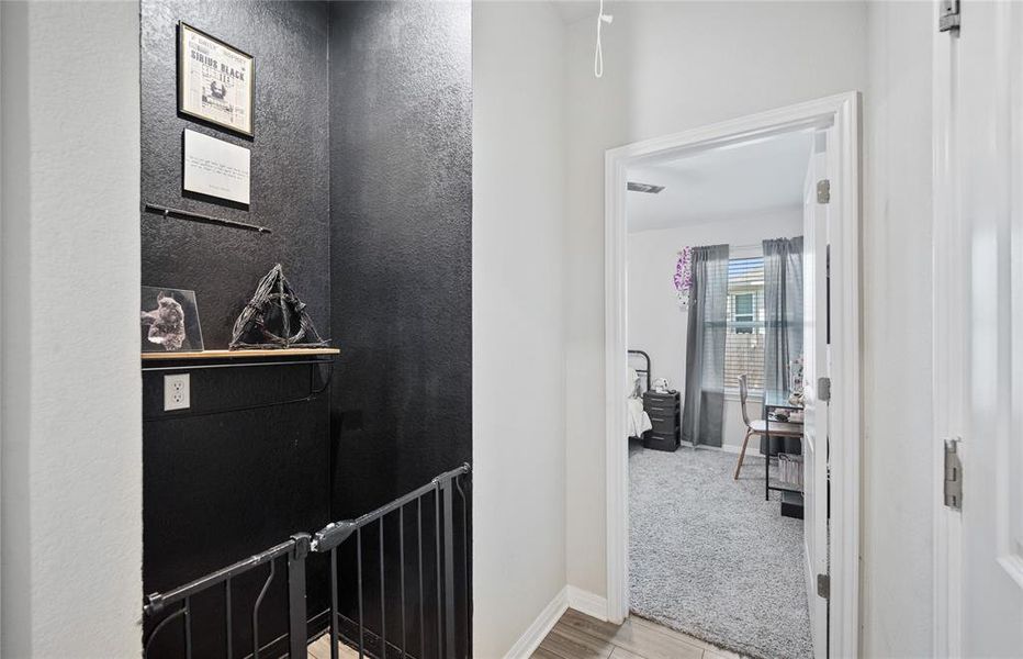 Hall with baseboards and light carpet