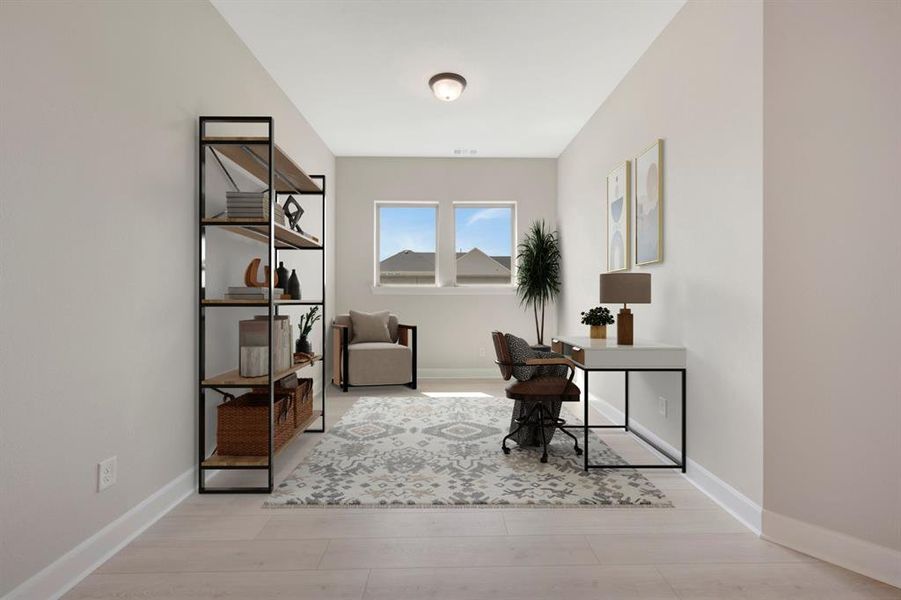 Bright room featuring wood-finish flooring, two windows with natural light, and a flush mount ceiling light