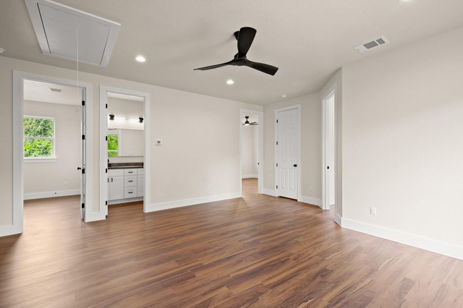 Spare room featuring attic access, dark wood finished floors, recessed lighting, and ceiling fan