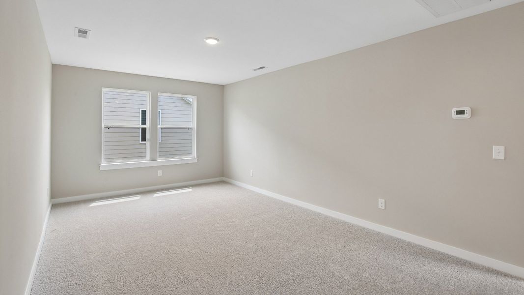 Second Floor Loft area with windows and carpet