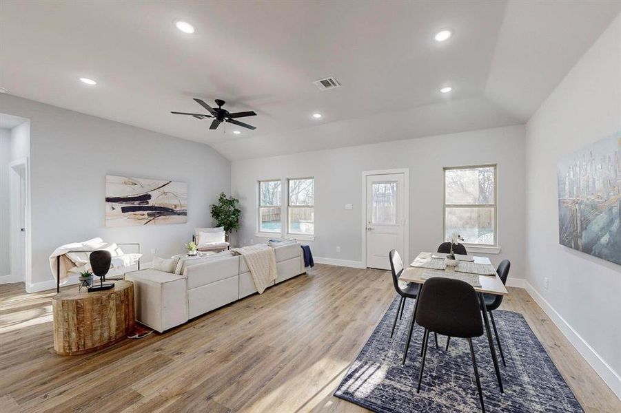 Dining space featuring lofted ceiling, light hardwood / wood-style floors, and ceiling fan