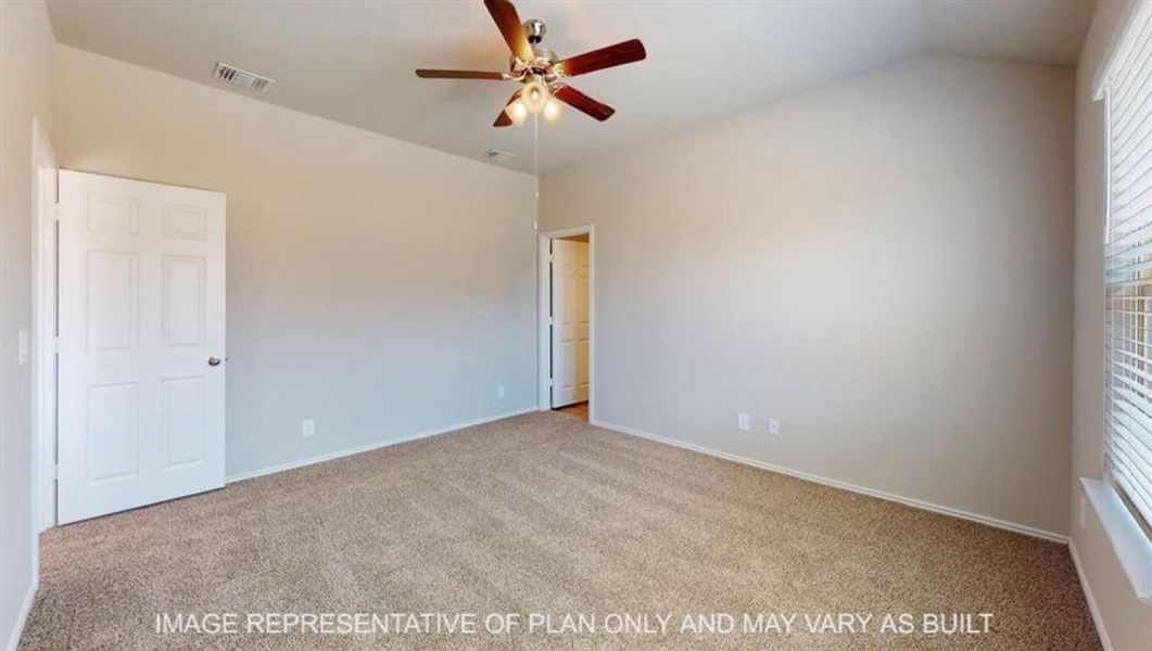 Spacious room featuring vaulted ceilings, light-colored carpeting, a multi-paneled door, and a ceiling fan with integrated lighting