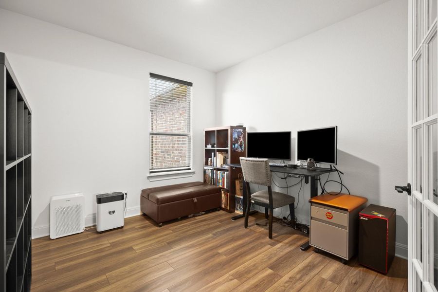 Office area with wood finished floors and baseboards Office area with wood finished floors and baseboards