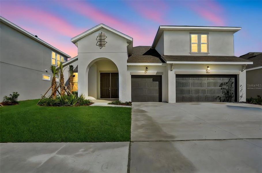 Front exterior of a new home in Angeline, Land O' Lakes, FL, highlighting curb appeal (Image 24).