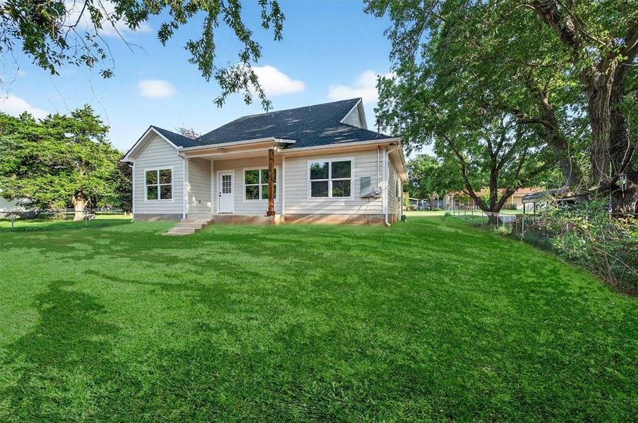 Back of house with a shingled roof Back of house with a shingled roof