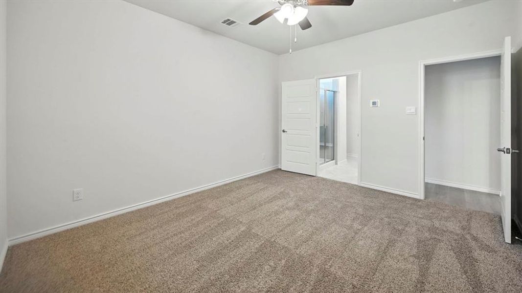 Unfurnished bedroom featuring carpet flooring and ceiling fan